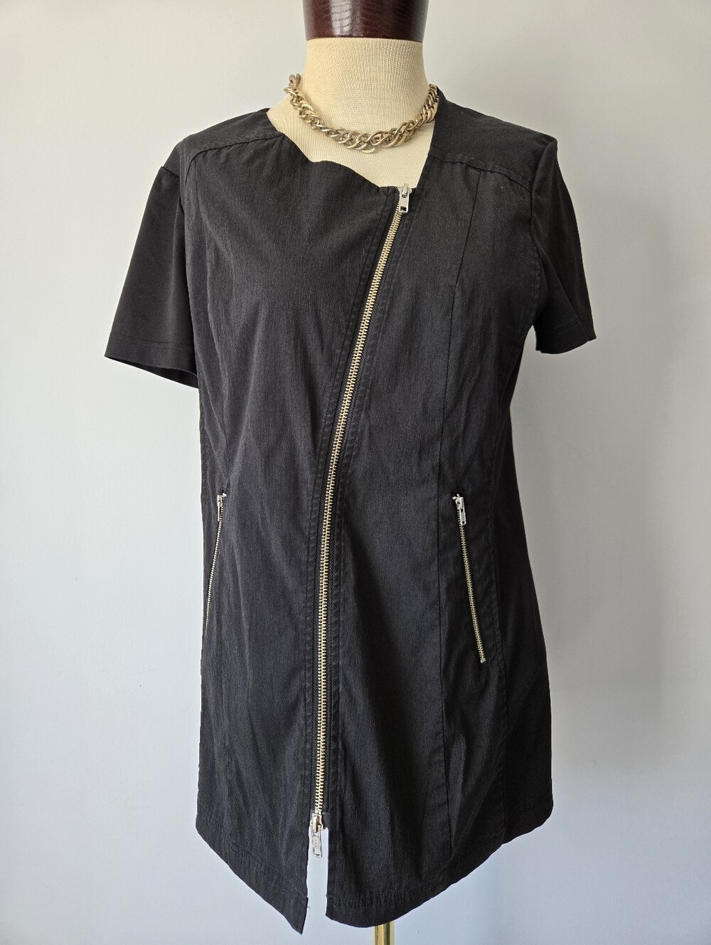 Noel Asmar Uniforms Short Sleeve Zip-Front Tunic with Gold Asymmetrical Zip.